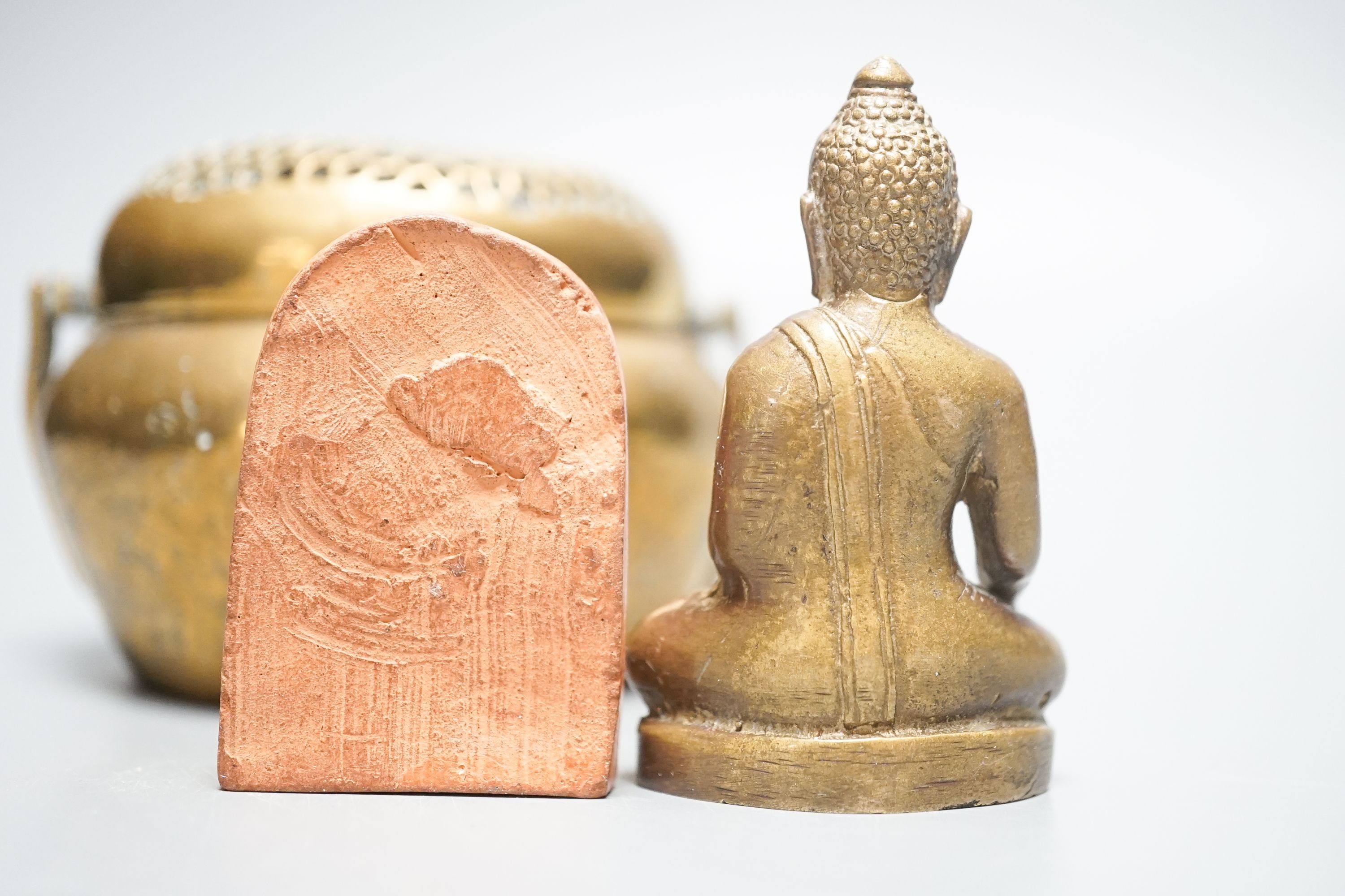 A bronze hand warmer with Xuande mark, 10 cm wide and two Himalayan Buddhist figures, tallest 6.8 cm (3)